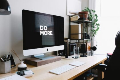 Minimal office desk with motivational screen message.