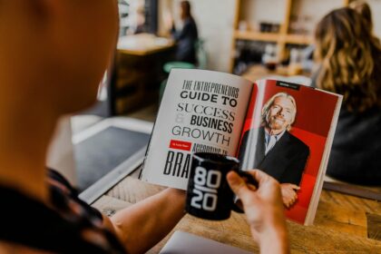 Person reading business growth guide magazine.