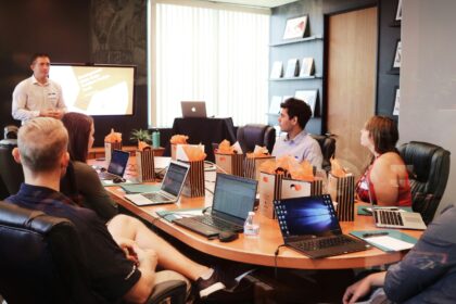 Team meeting with presentation and laptops.